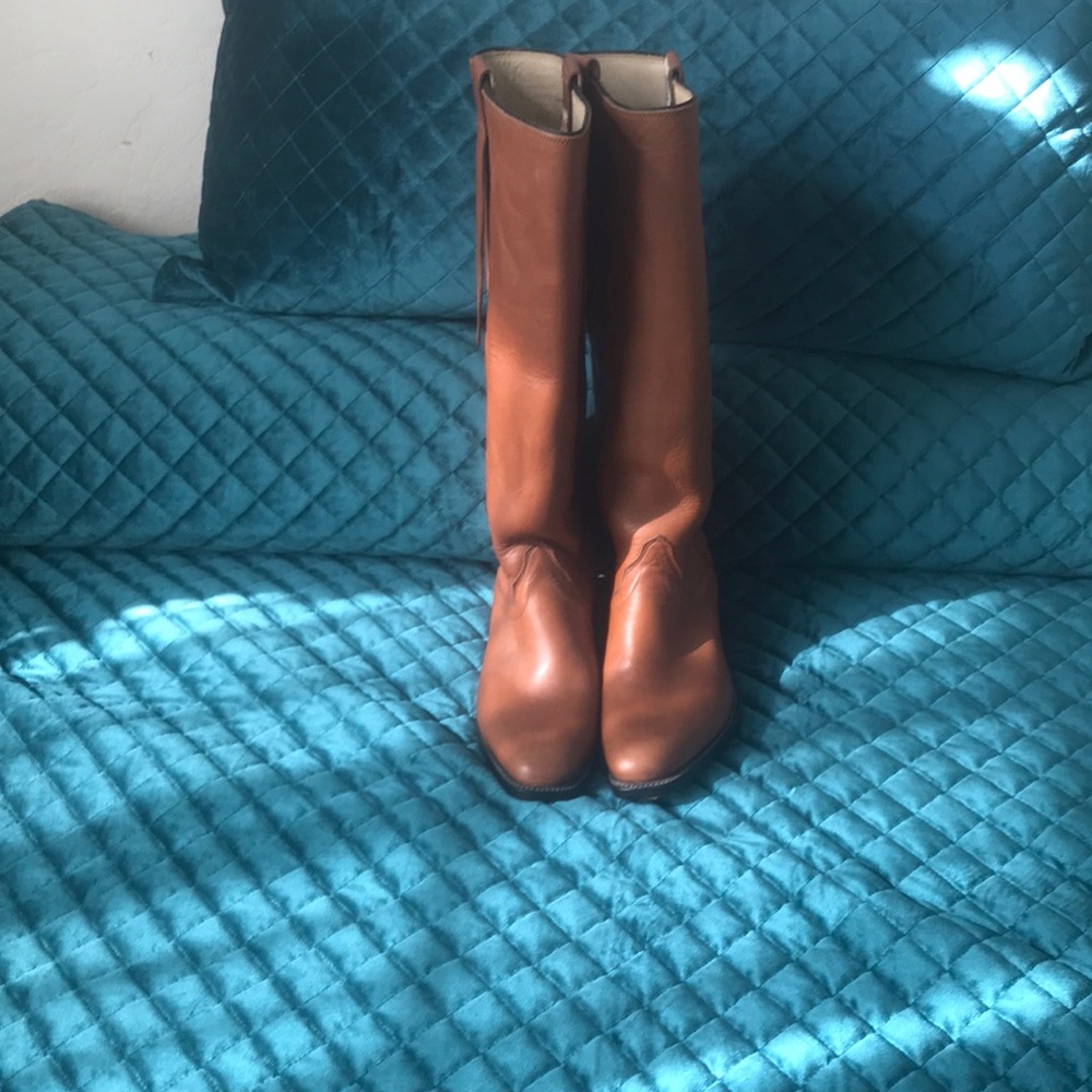 Tall camel color men’s cowboy boots.